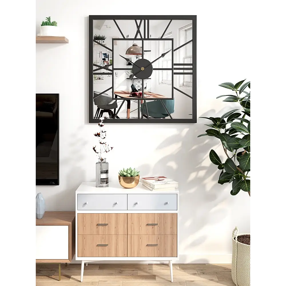 Metal frame square wall clock reflecting light in bright room