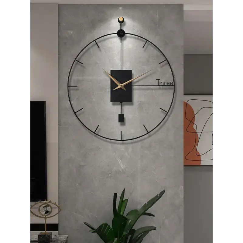 Black modern wall clock mounted in a contemporary living room