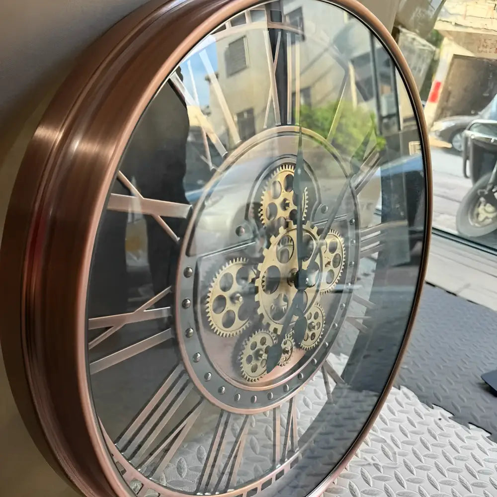 Industrial wall clock in copper finish mounted on living room wall