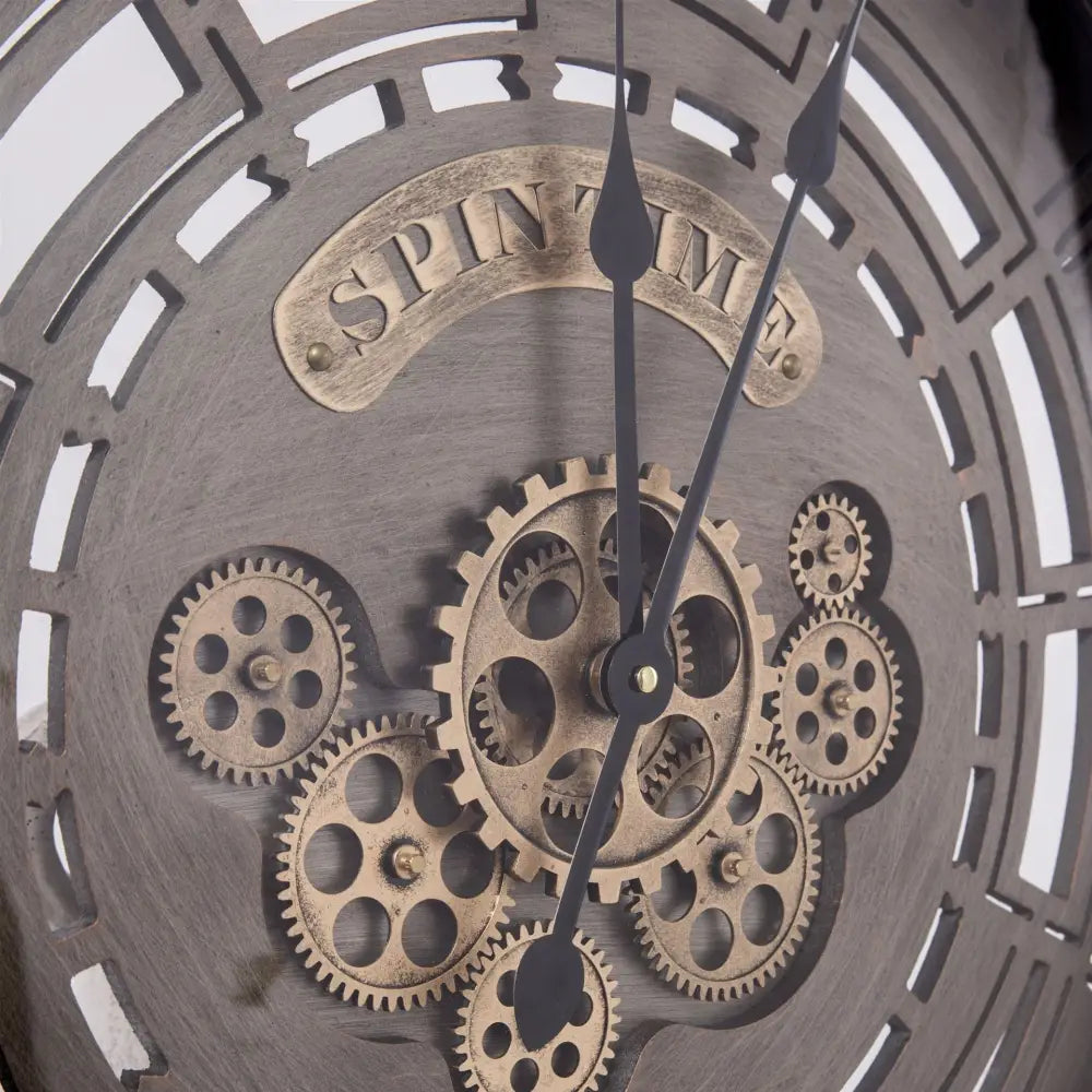 Close-up of spinning gear detail on large industrial metal wall clock