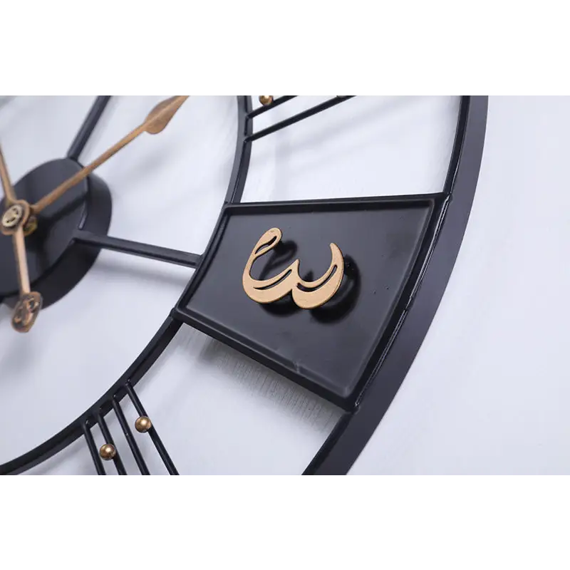 Black and silver numeral metal wall clock above a home office desk