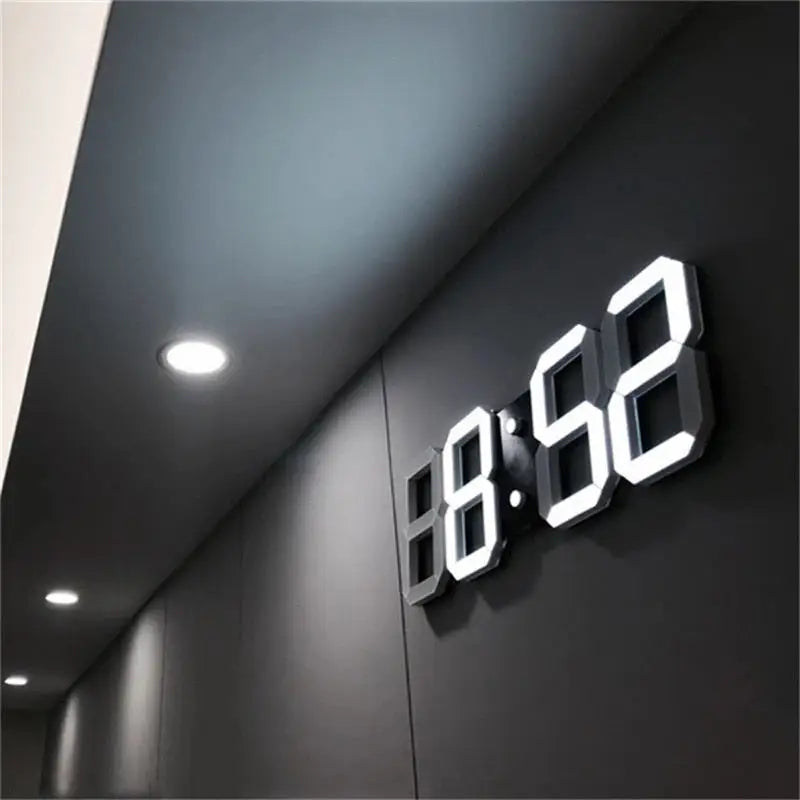 LED wall clock standing on kitchen countertop next to coffee maker