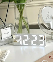 LED mirror digital clock showing time and temperature on a desk
