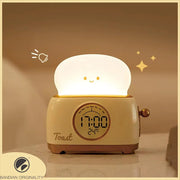 Green toaster-shaped LED kids alarm clock with night light on nightstand