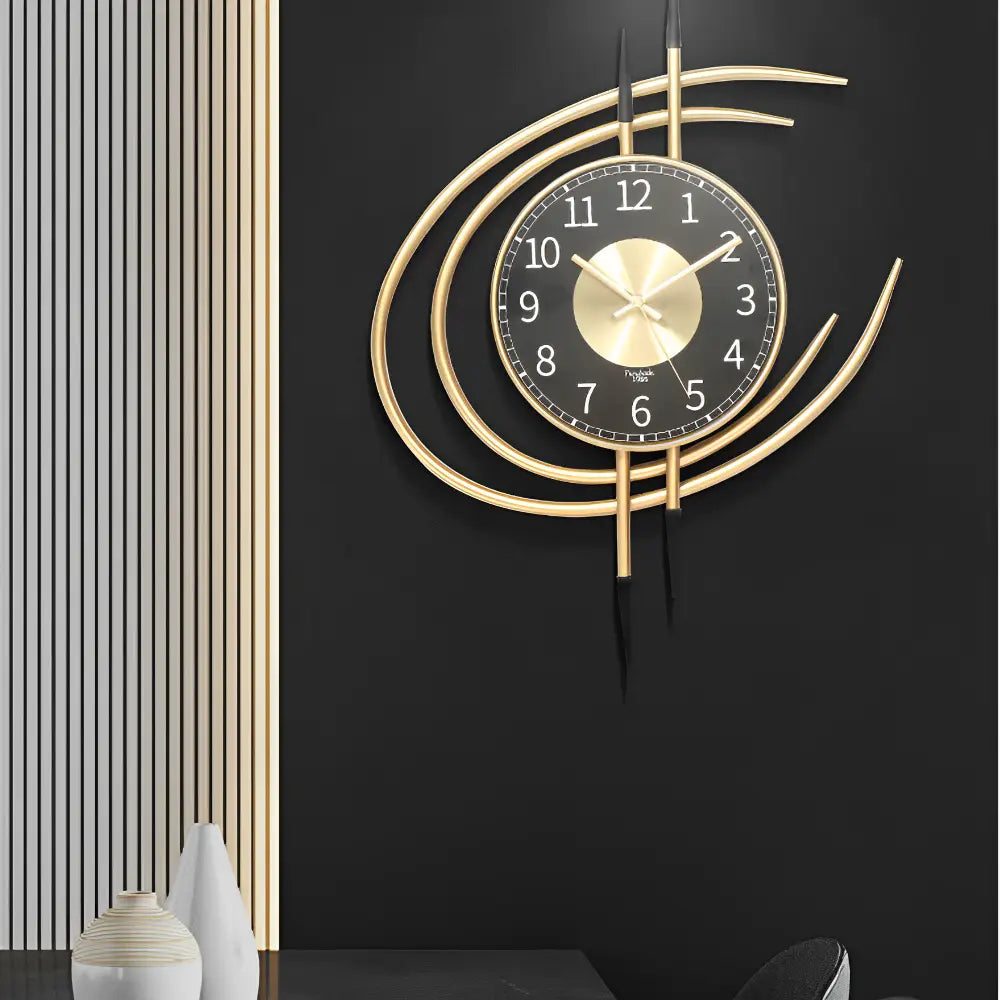 Close-up of analog hands on a designer gold black metal wall clock