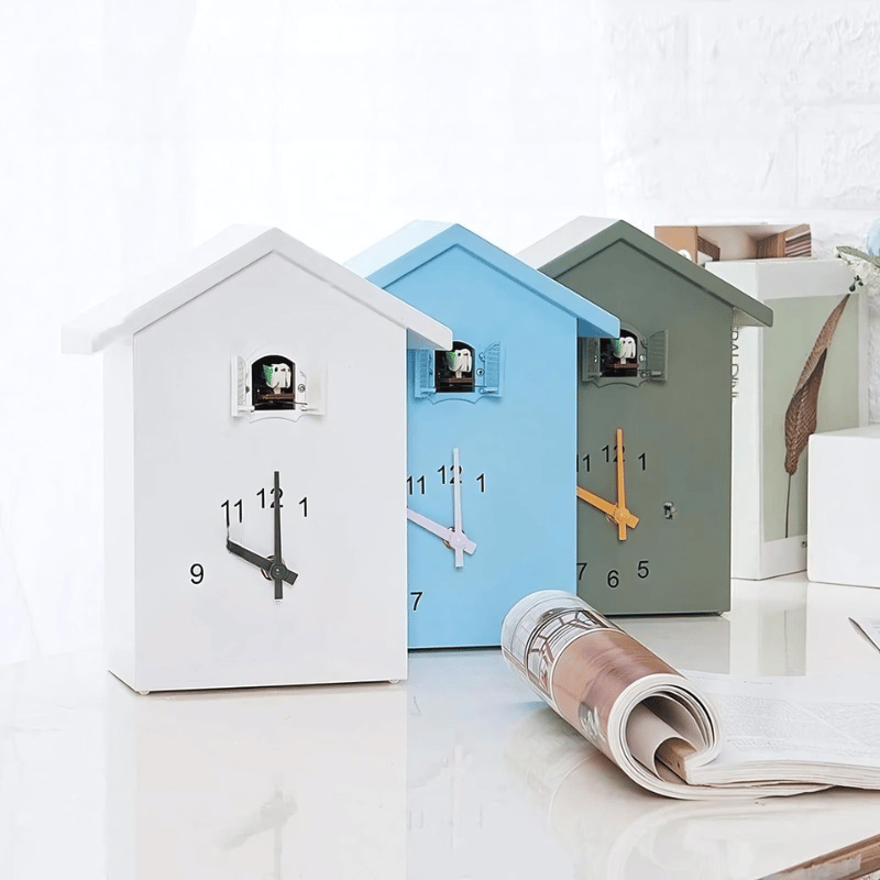 Blue and white modern cuckoo clock mounted on living room wall