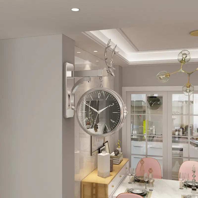 Silver and white double-sided wall clock showing both clock faces