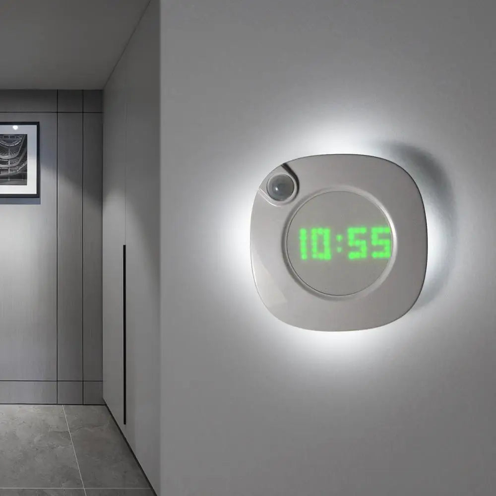 Square acrylic digital wall clock glowing in low light