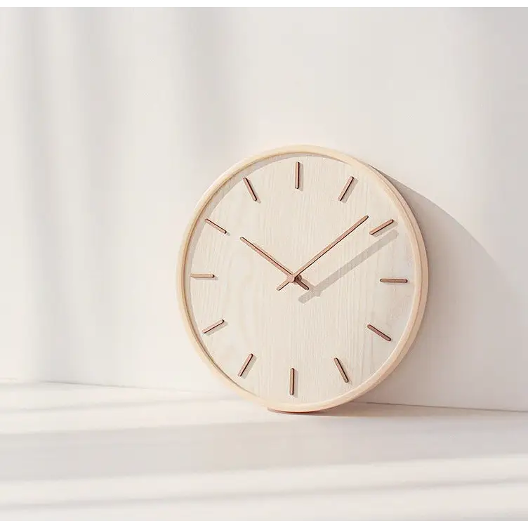 Dark wood bamboo wall clock close-up showing analog hands and natural grain
