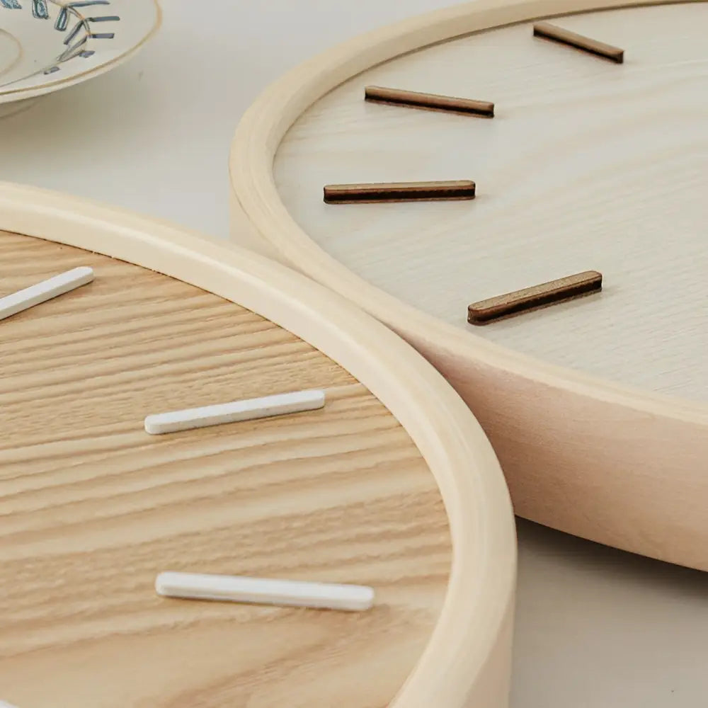 Natural wood wall clock in a minimalist bedroom setting