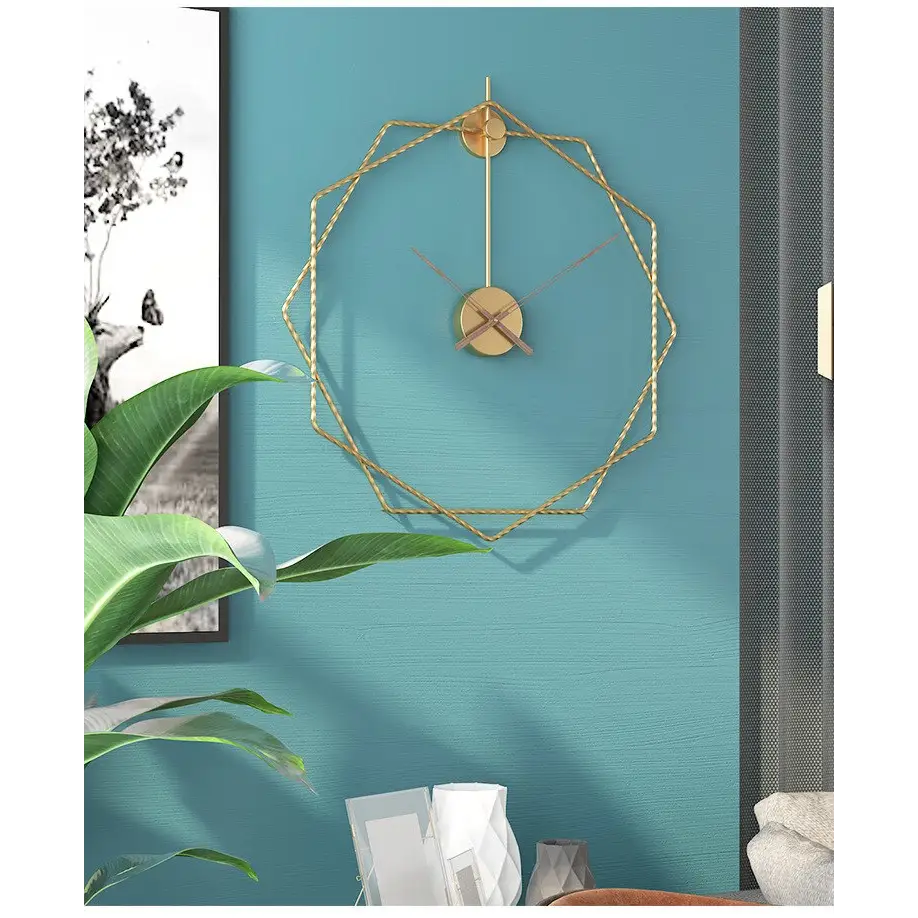 Geometric octagon wall clock in gold finish above a modern sofa