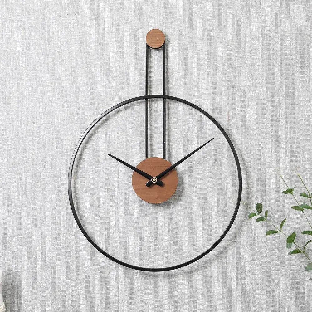 Gold suspended circle wall clock close-up showing analog hands and metal frame