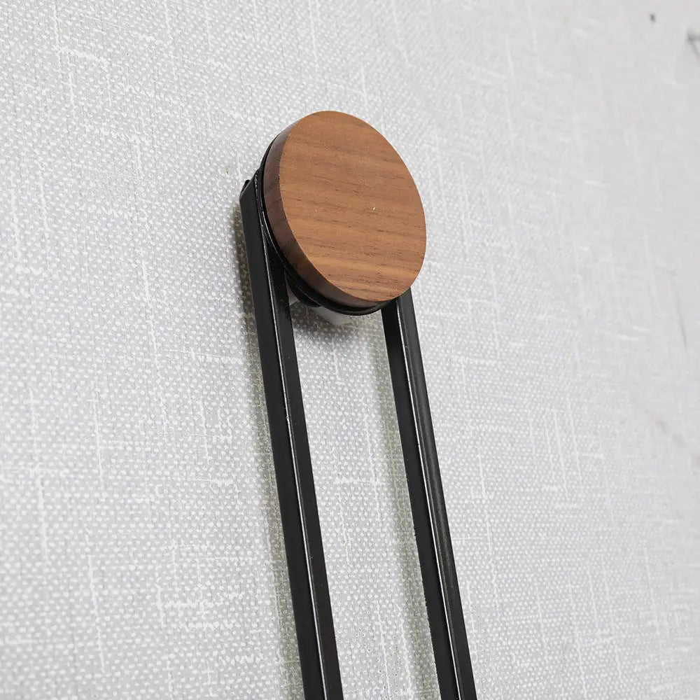 Overhead flat-lay of suspended circle wall clock showing metal construction and finish detail