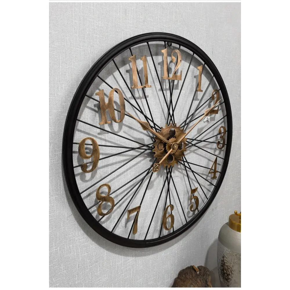 Gold industrial gear wall clock on white wall