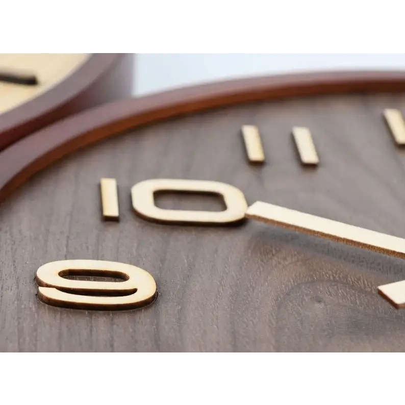 Walnut wall clock in a kitchen setting showing clean round design